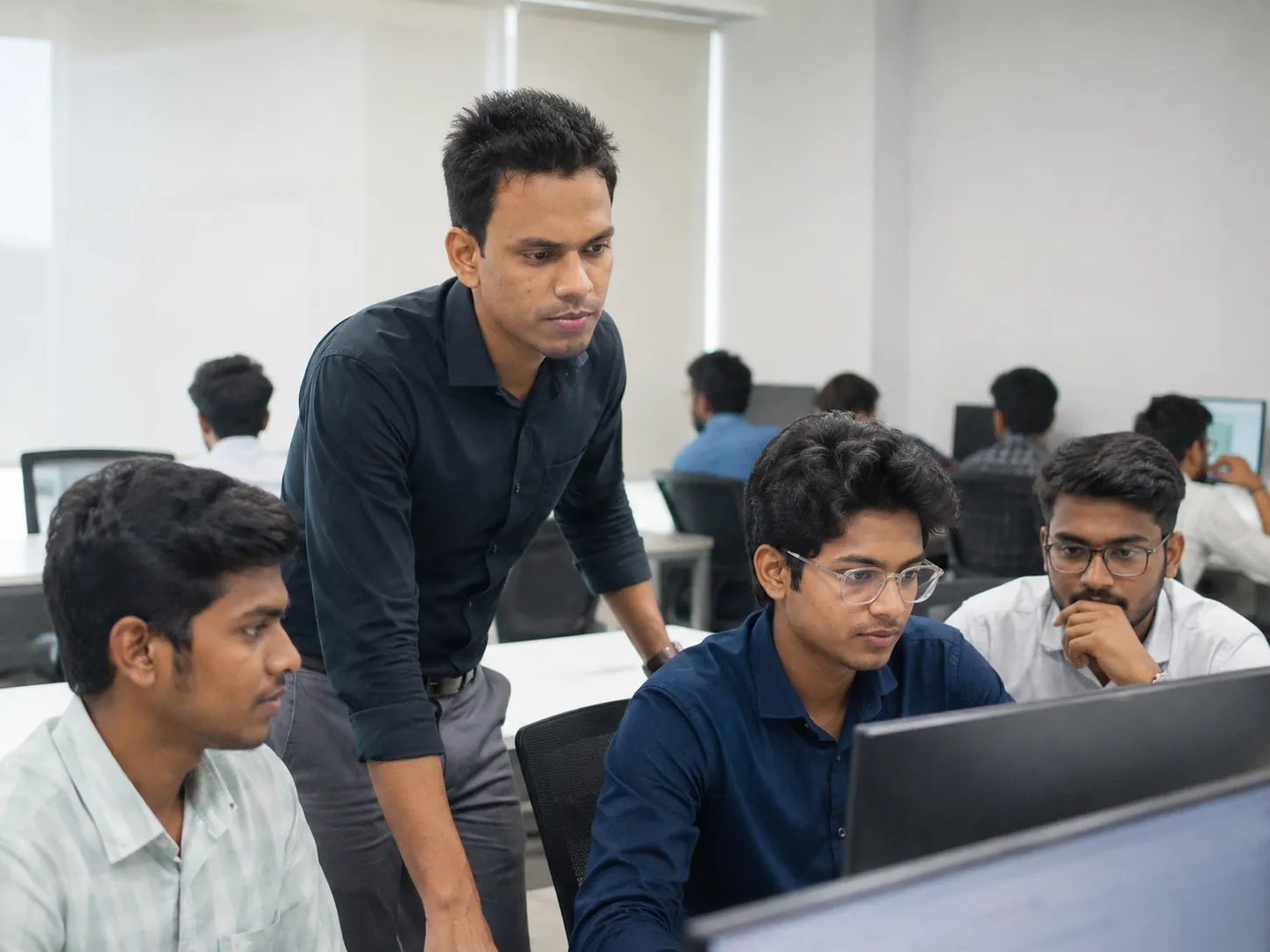 Train-and-Hire cohort at work on a capstone project